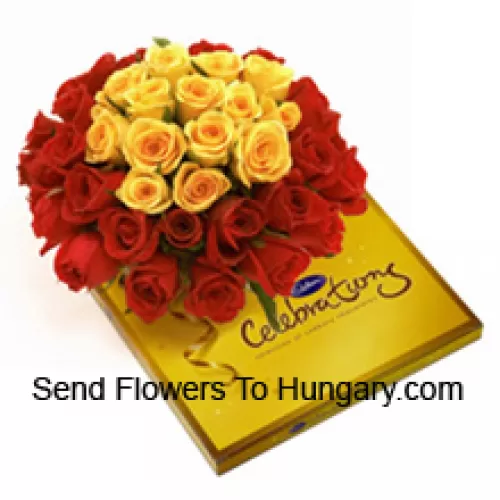 Bouquet de 24 roses rouges et 11 jaunes avec des garnitures de saison accompagné d'une belle boîte de chocolats Cadbury